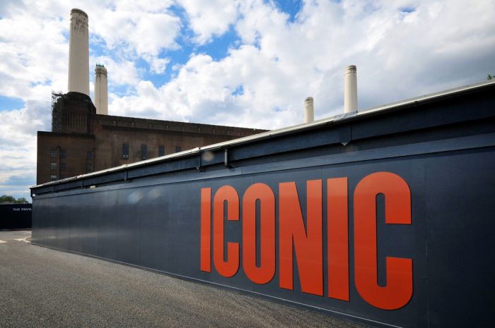 cut letters saying 'iconic' on a hoarding at Battersea power station
