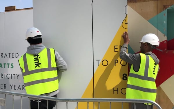 2 Octink installers moving a hoarding panel on this advertising hoardings FAQ