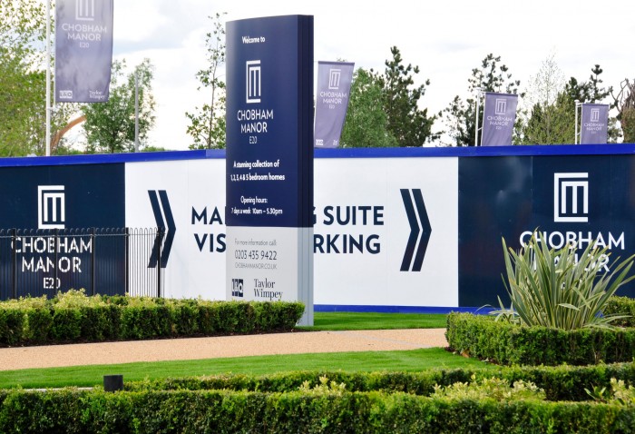 Chobham manor hoarding with directional signage and free standing totem